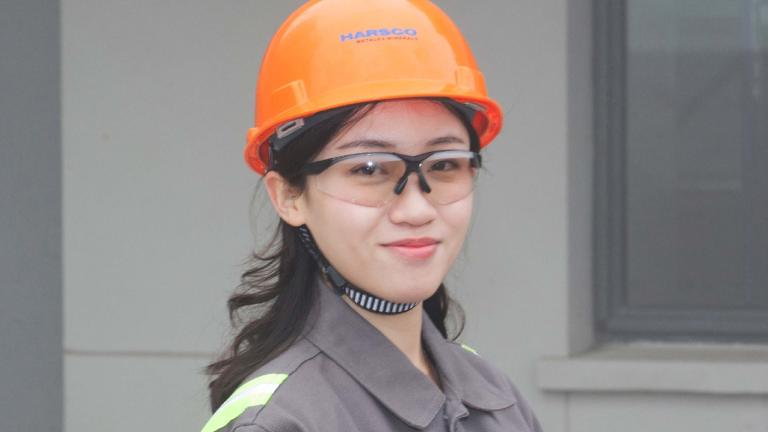 Woman in safety glasses and a hard hat