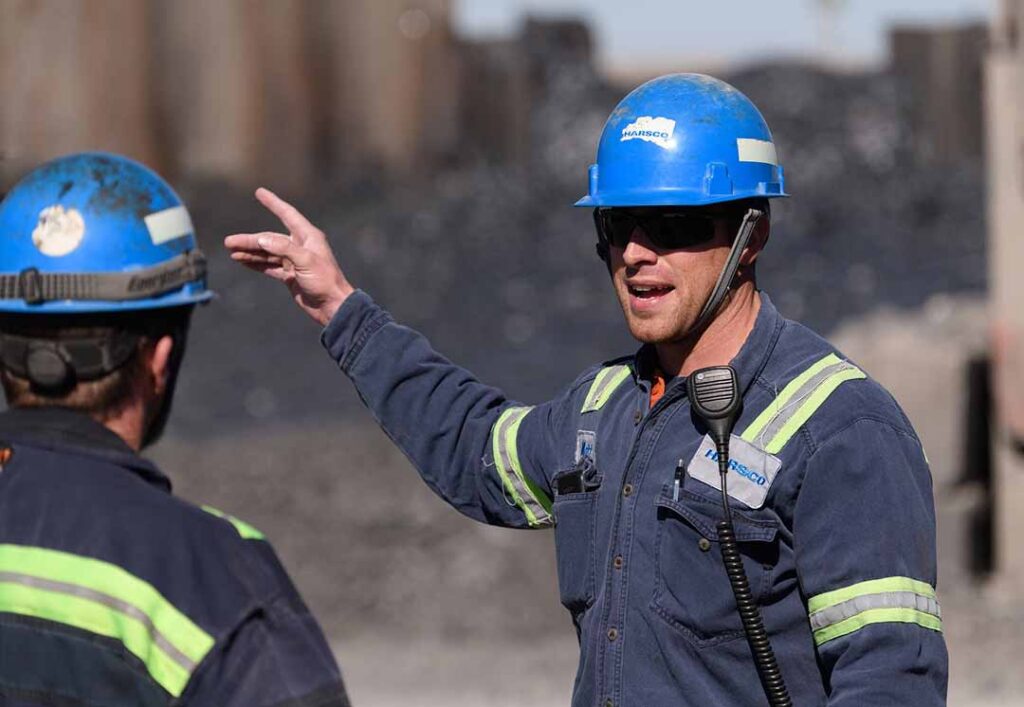 Construction worker talking to another while pointing